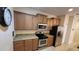 Cozy kitchen featuring wooden cabinets, granite countertops, and stainless steel appliances at 8974 California Palm Rd, Kissimmee, FL 34747