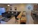 Stylish living room with a comfortable gray sectional sofa, ceiling fan, and breakfast bar seating at 8974 California Palm Rd, Kissimmee, FL 34747