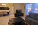 Comfortable living room featuring a TV, and dining area in the background at 8974 California Palm Rd, Kissimmee, FL 34747