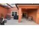 Spacious covered patio with comfortable seating, a grill, and tranquil outdoor living space at 8974 California Palm Rd, Kissimmee, FL 34747