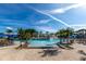 Stunning resort-style pool with rock waterfall feature, palm trees, and plenty of lounge chairs for relaxation at 8974 California Palm Rd, Kissimmee, FL 34747
