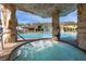Relaxing pool area with waterfall and hot tub, surrounded by lush landscaping at 8974 California Palm Rd, Kissimmee, FL 34747