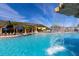 Inviting community pool with a waterfall feature, surrounded by palm trees and lounge chairs for relaxation at 8974 California Palm Rd, Kissimmee, FL 34747