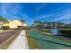 Enjoy a game of shuffleboard at the community's recreation area amidst lush landscaping and palm trees on a clear sunny day at 8974 California Palm Rd, Kissimmee, FL 34747