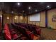 Spacious theater room with comfortable seating, a large screen, and professional-grade equipment for the ultimate movie experience at 8974 California Palm Rd, Kissimmee, FL 34747