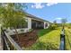 Exterior shot of home showcasing a well-kept lawn and screened patio at 937 Walnut Creek Ln, Poinciana, FL 34759