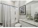 Bright bathroom with a shower-tub combo, white tiling, and granite vanity top at 937 Walnut Creek Ln, Poinciana, FL 34759