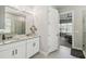 Bright bathroom with double vanity, granite counters, and glass-enclosed shower; connected to the main bedroom at 937 Walnut Creek Ln, Poinciana, FL 34759