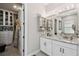 Bathroom vanity with granite countertops and walk-in closet at 937 Walnut Creek Ln, Poinciana, FL 34759