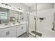 Bright bathroom featuring a double sink vanity, a glass-enclosed shower and upgraded fixtures at 937 Walnut Creek Ln, Poinciana, FL 34759