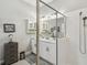 Elegant bathroom featuring a glass shower enclosure, double vanity with modern fixtures, and ample storage at 937 Walnut Creek Ln, Poinciana, FL 34759