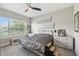 A serene bedroom featuring a large window, neutral color palette, and stylish furnishings at 937 Walnut Creek Ln, Poinciana, FL 34759