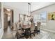 Well-lit dining room with neutral tones, a wooden dining table, and a decorative buffet at 937 Walnut Creek Ln, Poinciana, FL 34759