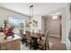 Elegant dining room with stylish lighting, modern decor, and a view of the neighborhood at 937 Walnut Creek Ln, Poinciana, FL 34759