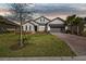 Inviting single-Gathering home with a brick driveway, well-maintained lawn, and neutral exterior paint at 937 Walnut Creek Ln, Poinciana, FL 34759