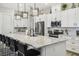 A gourmet kitchen featuring granite countertops, stainless steel appliances, and stylish lighting fixtures at 937 Walnut Creek Ln, Poinciana, FL 34759