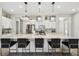 Modern kitchen featuring a large island with bar seating, stainless steel appliances, and white cabinetry at 937 Walnut Creek Ln, Poinciana, FL 34759