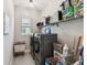 Laundry room with modern washer and dryer units and ample storage shelving at 937 Walnut Creek Ln, Poinciana, FL 34759