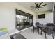 Covered patio space with fan, outdoor seating, and sliding glass doors at 937 Walnut Creek Ln, Poinciana, FL 34759