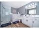Modern bathroom with a glass-enclosed shower, soaking tub, and white vanity at 1113 Pine Ridge Dr, Davenport, FL 33896
