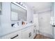 Bright bathroom features a large vanity with black hardware, tub-shower combo, and neutral color palette at 1113 Pine Ridge Dr, Davenport, FL 33896