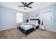 Beautiful bedroom offering soft carpet flooring, a ceiling fan and a queen bed with a plush, tufted headboard at 1113 Pine Ridge Dr, Davenport, FL 33896