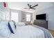 Bright bedroom featuring two twin beds, playful decor, and plenty of natural light from the large window at 1113 Pine Ridge Dr, Davenport, FL 33896