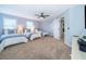 Bright bedroom featuring three twin beds with soft, neutral decor and plush carpet at 1113 Pine Ridge Dr, Davenport, FL 33896