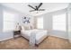 This bedroom boasts natural light with a ceiling fan, plush carpeting and simple yet stylish decor at 1113 Pine Ridge Dr, Davenport, FL 33896