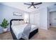 Bright bedroom features a plush bed, neutral paint, ceiling fan, and a large window at 1113 Pine Ridge Dr, Davenport, FL 33896