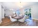 Open concept dining room with stylish furnishings and sliding glass doors to the backyard at 1113 Pine Ridge Dr, Davenport, FL 33896