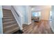 Welcoming entryway with carpeted stairs, modern flooring, and access to living area at 1113 Pine Ridge Dr, Davenport, FL 33896