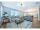 Spacious living area with stylish furniture and an open layout connecting to the dining space at 1113 Pine Ridge Dr, Davenport, FL 33896