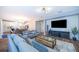 Open-concept living space with modern decor, sleek flooring, and seamless flow to dining area at 1113 Pine Ridge Dr, Davenport, FL 33896