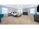 Spacious main bedroom with plush carpet, a king bed, and ambient lighting at 1113 Pine Ridge Dr, Davenport, FL 33896