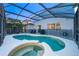 The screened in pool and spa offer backyard retreat at 1113 Pine Ridge Dr, Davenport, FL 33896