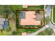 Aerial view of barrel tile roof home with pool, enclosure, landscaping, and red property line at 11856 Vinci Dr, Windermere, FL 34786