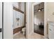 Bright bathroom featuring unique shower curtain and access to the bedroom with dark wood floors at 11856 Vinci Dr, Windermere, FL 34786