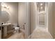 Half bathroom with pedestal sink and toilet in hallway with tile flooring at 11856 Vinci Dr, Windermere, FL 34786
