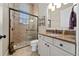 Well-lit bathroom featuring glass shower, neutral tile, granite counters, and decorative accessories at 11856 Vinci Dr, Windermere, FL 34786