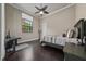 This charming bedroom has hardwood floors, a ceiling fan and a large window at 11856 Vinci Dr, Windermere, FL 34786