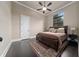 Bedroom boasts dark hardwood floors, crown molding, a ceiling fan and a window at 11856 Vinci Dr, Windermere, FL 34786