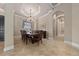Bright dining room featuring a large wooden table, seating for eight, stylish chandelier, and tile floors at 11856 Vinci Dr, Windermere, FL 34786