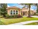 Charming single-Gathering home featuring a barrel tile roof, arched windows, and lush front lawn at 11856 Vinci Dr, Windermere, FL 34786