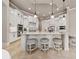 Bright kitchen with white cabinets, granite countertops, island with seating, and pendant lighting at 11856 Vinci Dr, Windermere, FL 34786