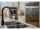 Kitchen sink with granite countertops, tiled backsplash, stainless steel appliances, and faucet at 11856 Vinci Dr, Windermere, FL 34786