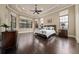 Spacious primary bedroom features tray ceilings, hardwood floors, and large windows at 11856 Vinci Dr, Windermere, FL 34786