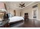 Spacious primary bedroom with hardwood floors, tray ceiling and ensuite bathroom at 11856 Vinci Dr, Windermere, FL 34786