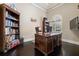 Home office featuring built-in bookcase, large desk, and plantation shutters for privacy at 11856 Vinci Dr, Windermere, FL 34786