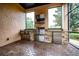 Outdoor kitchen with stainless steel appliances, brick accents, and ample counter space at 11856 Vinci Dr, Windermere, FL 34786